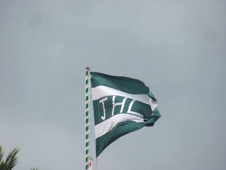 School flag of Jaffna Hindu Ladies College featuring sacred lamp and Veena emblems